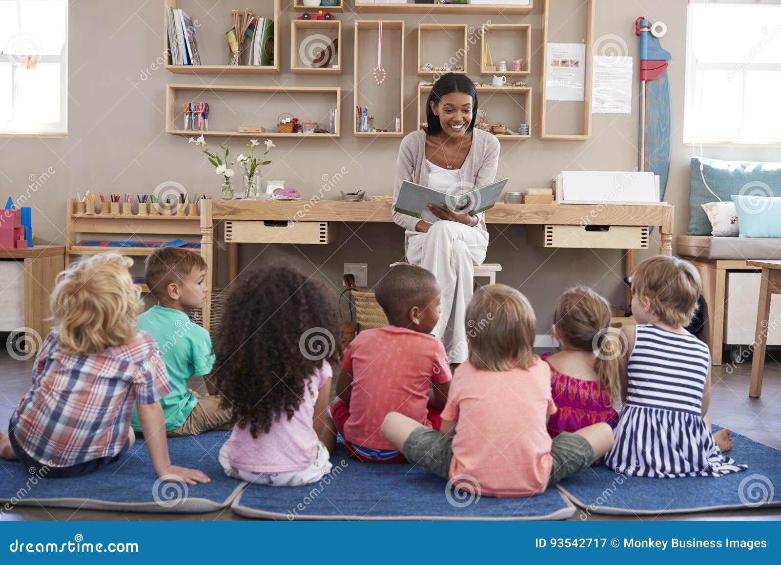 teacher at montessori school reading to children at story time