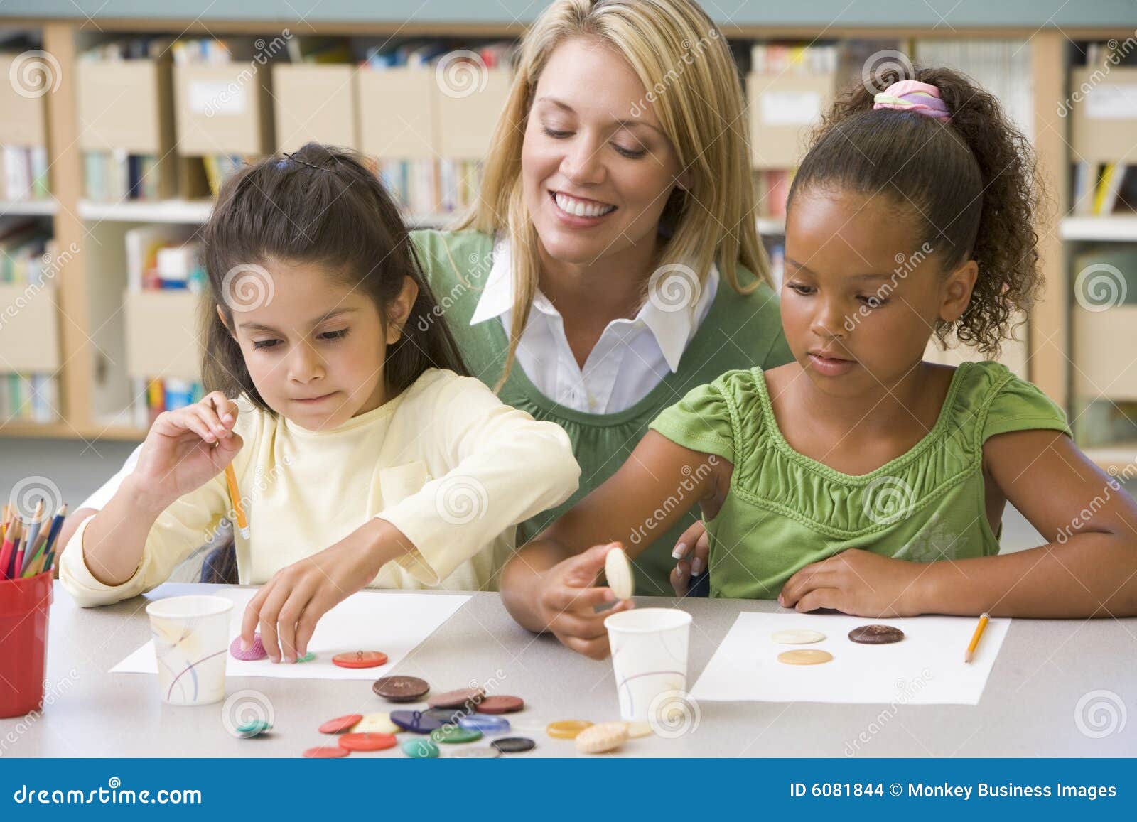 Teacher Sitting with Students in Art Class, Stock Photo - Image of