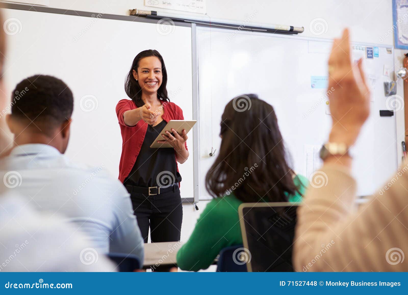 teacher with tablet and students at an adult education class