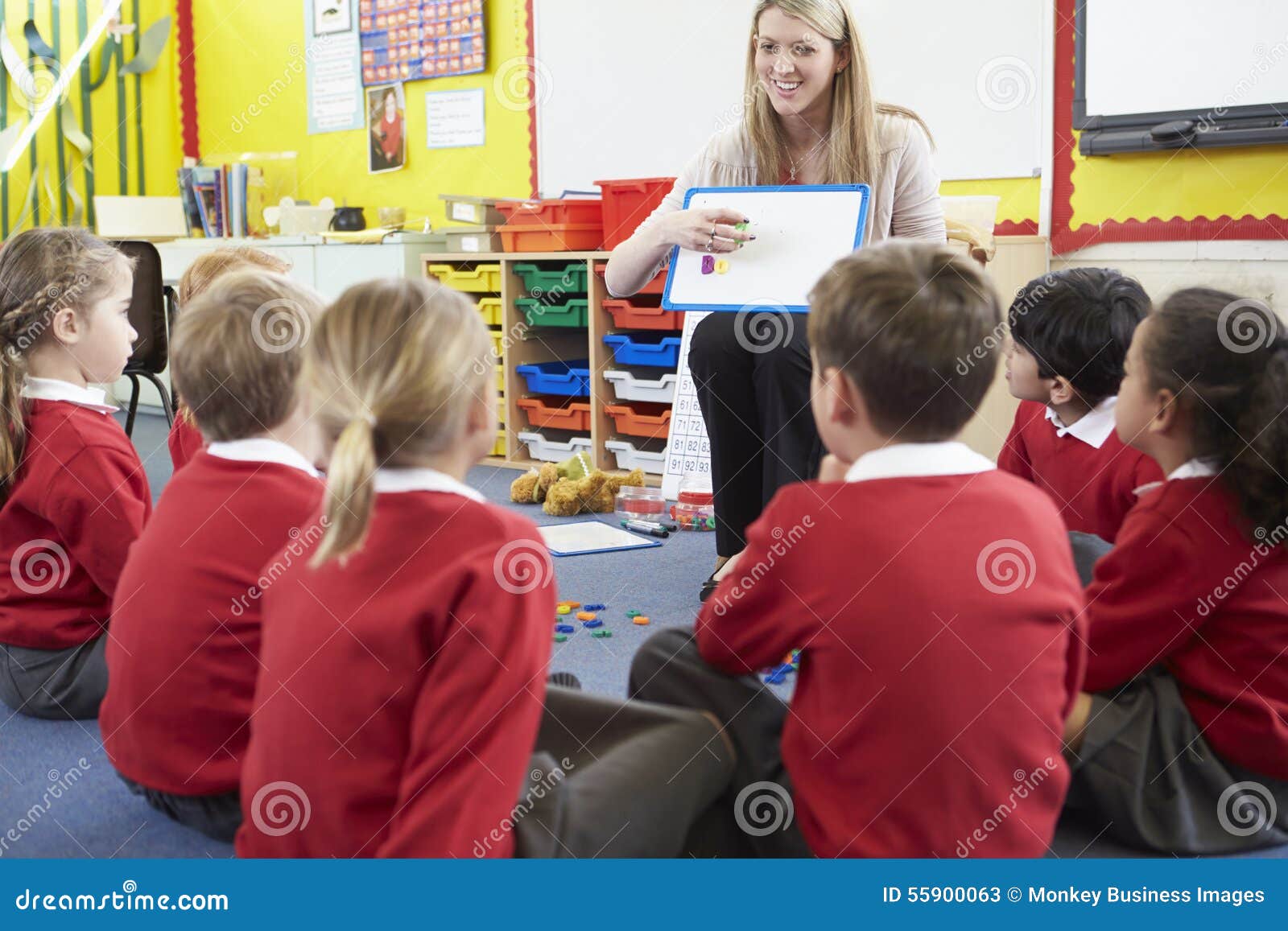 teacher teaching spelling to ary school pupils