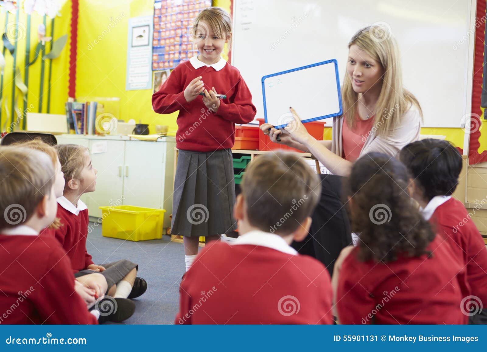 teacher teaching spelling to ary school pupils