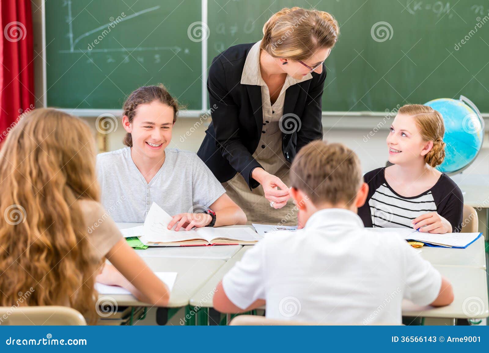 teacher teaching students geography lessons in school