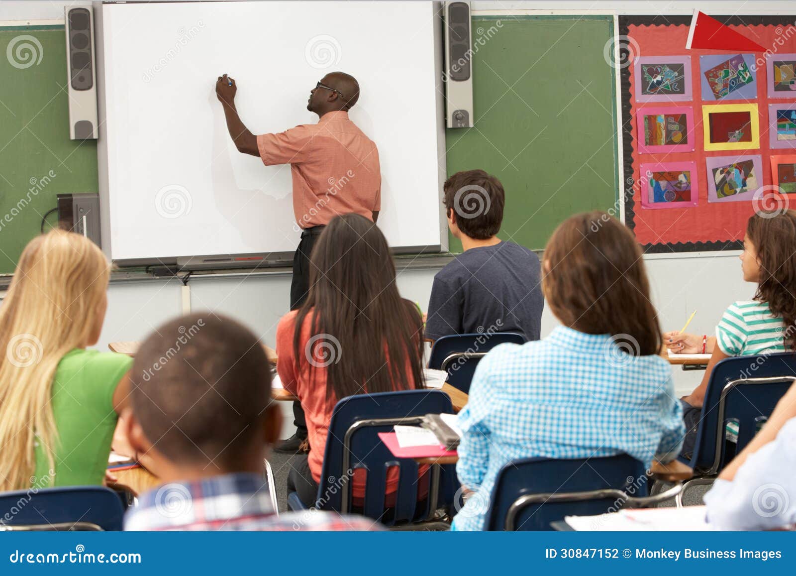 teacher using interactive whiteboard during lesson