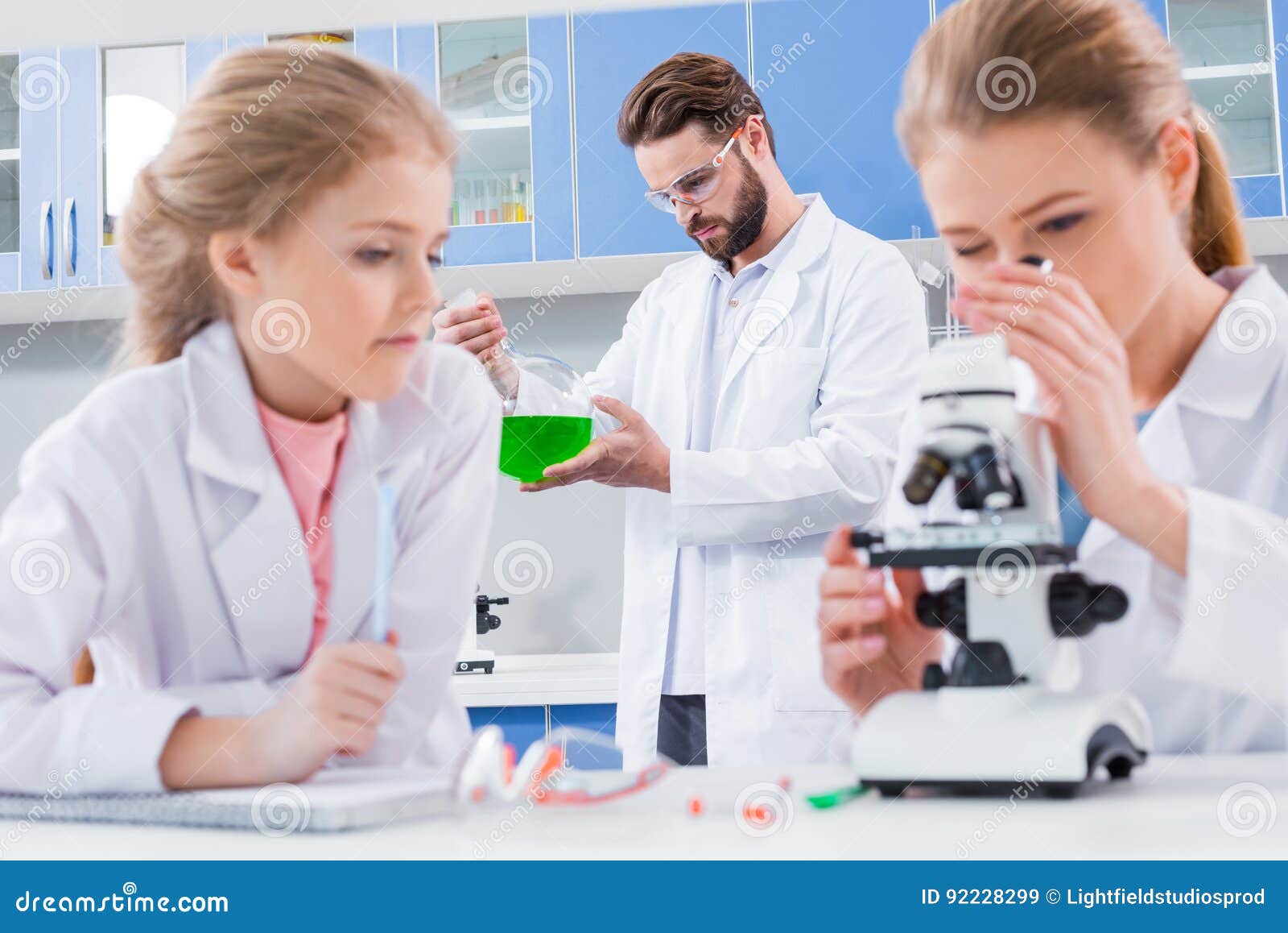 Teachers Scientists and Student Chemists in White Coats Working