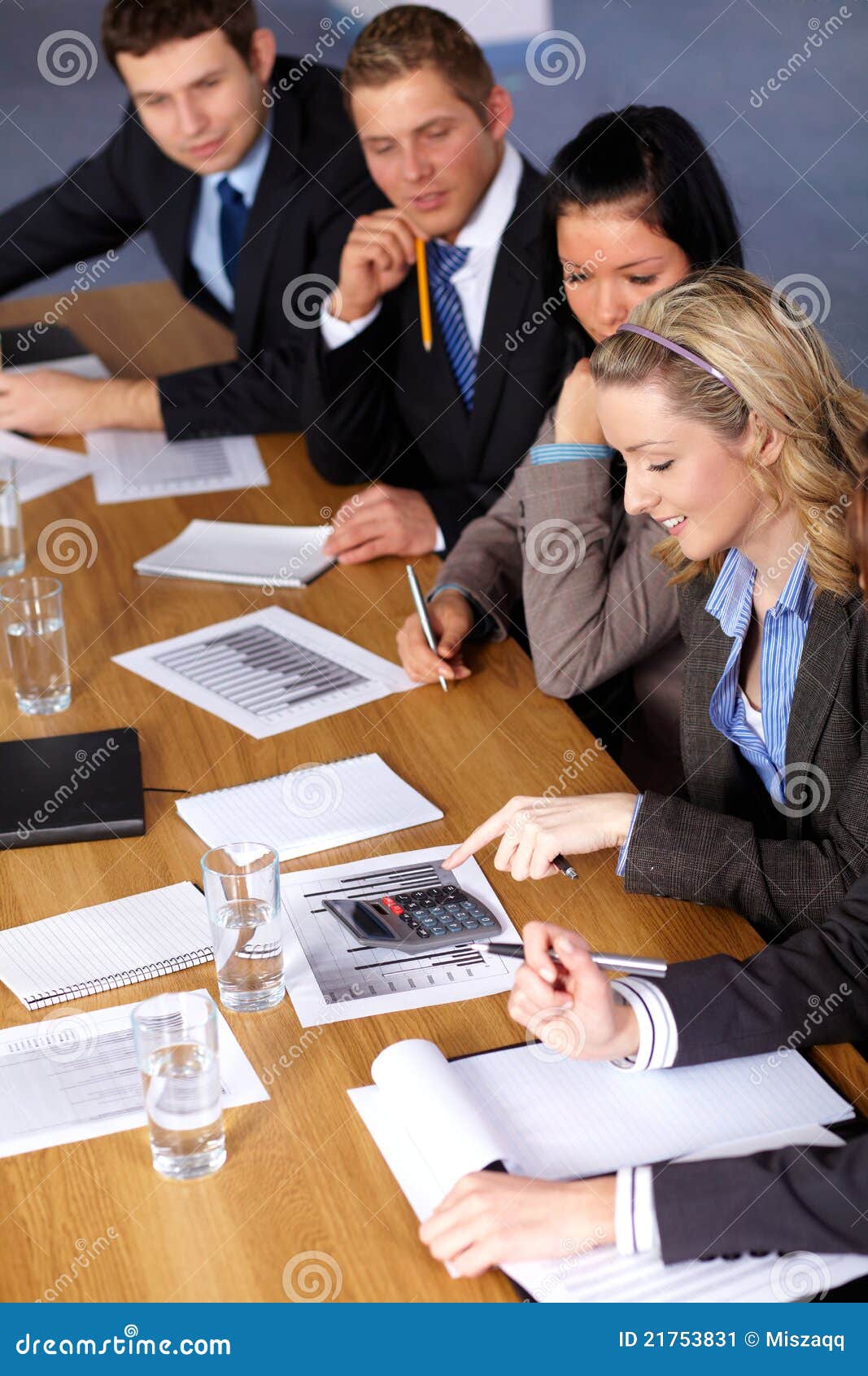 team of 5 business people working on calculations