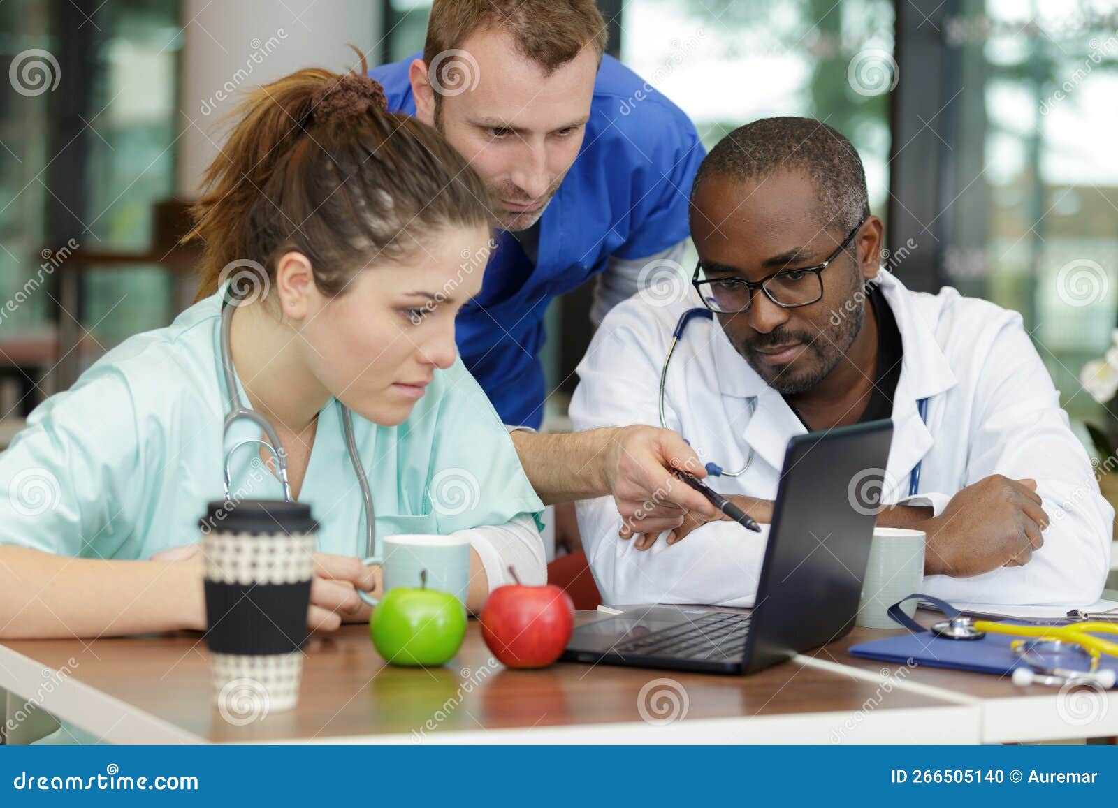 Team Doctors Using Desktop Pc Together during Lunch Time Stock Photo