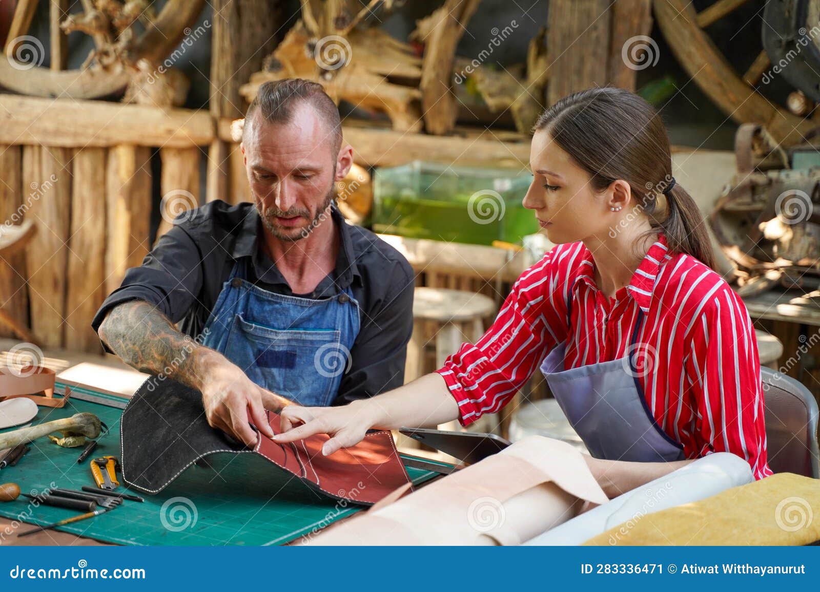 team of leather craftsman looking and check the neatness of the leathers bag before sell to customer