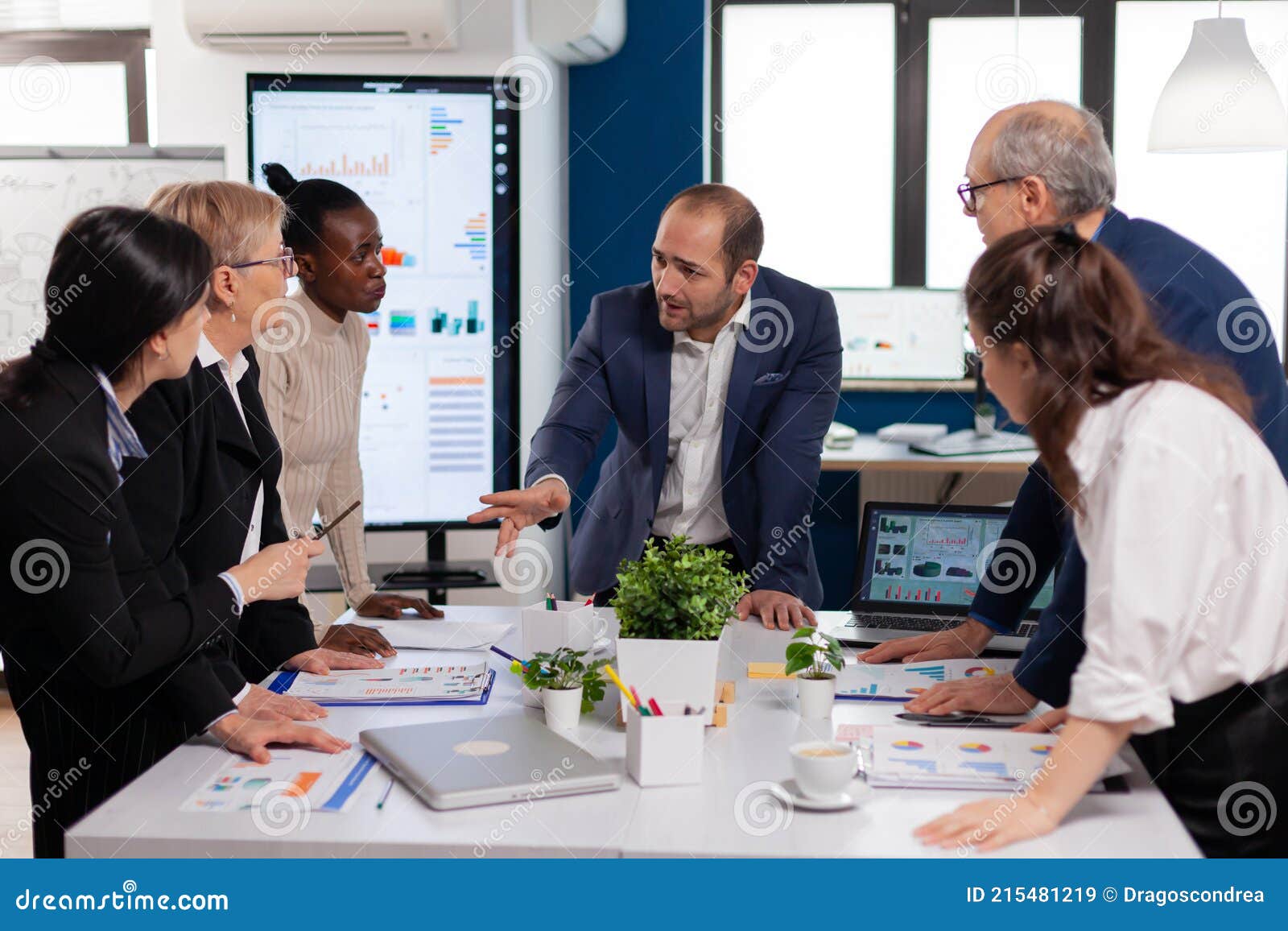 team manager in startup business discussing with mixedrace coworkers
