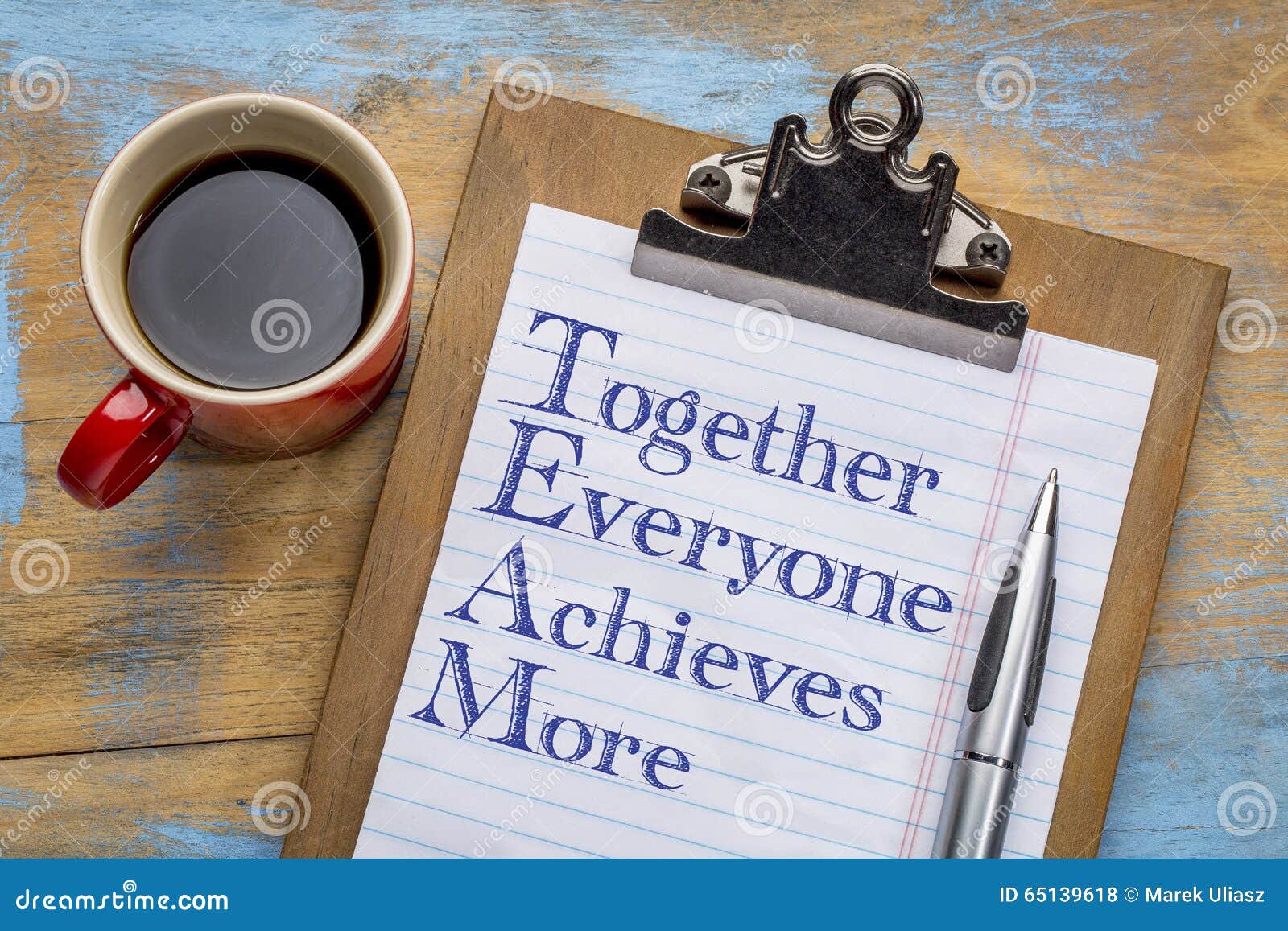 TEAM - together everyone achieves more acronym. TEAM acronym - together everyone achieves more - motivational text on a clipboard with a cup of coffee