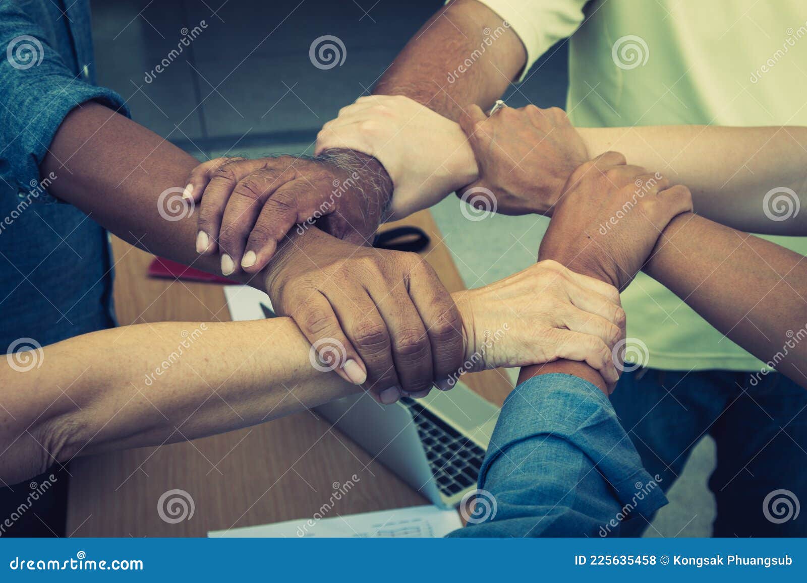 team work concept; close up of joining hands of businessman in unity cross processing background