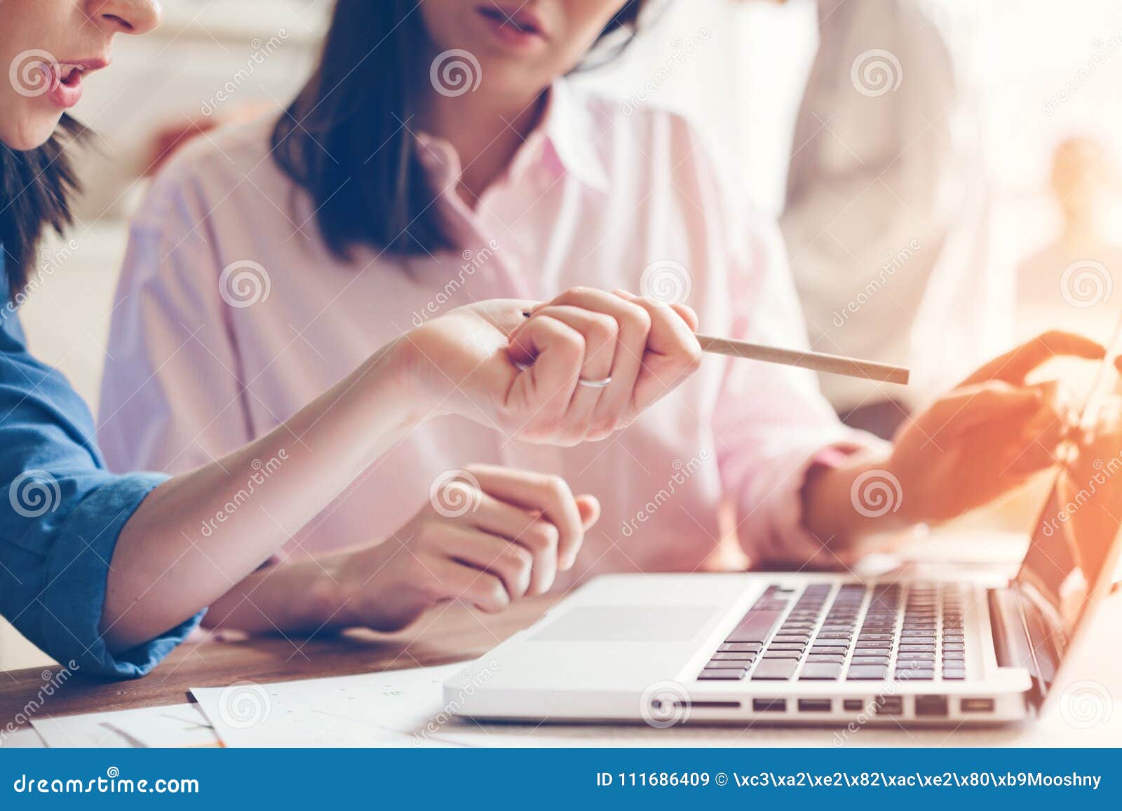 team work process. two women with laptop in open space office. business concept