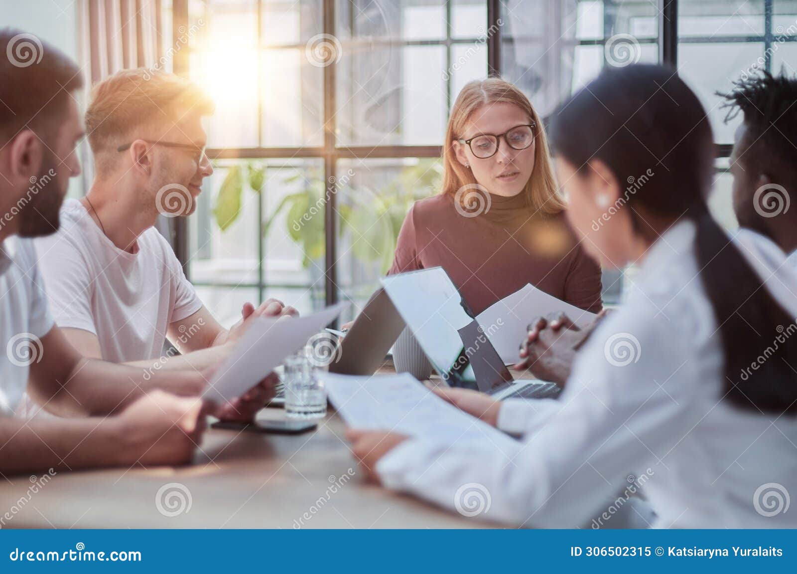 team working at desks in busy office