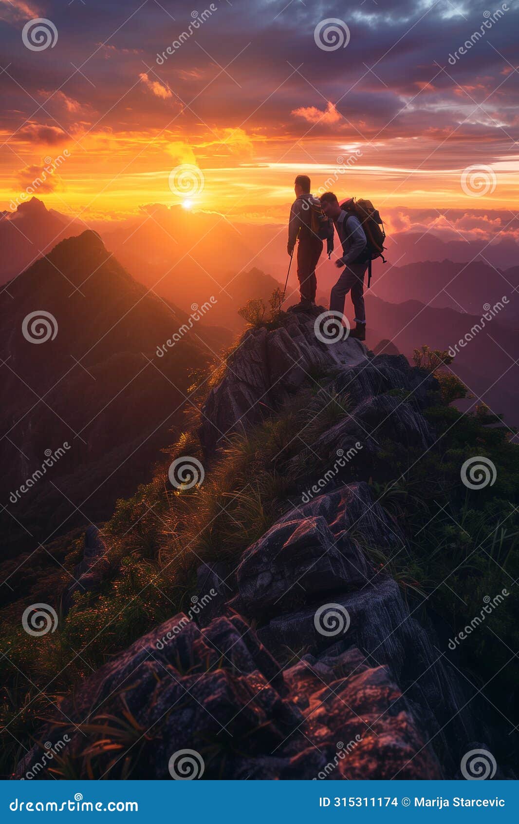 teamwork concept. two friends hikers climbing on the top of the mountain and helping eachother. ledership