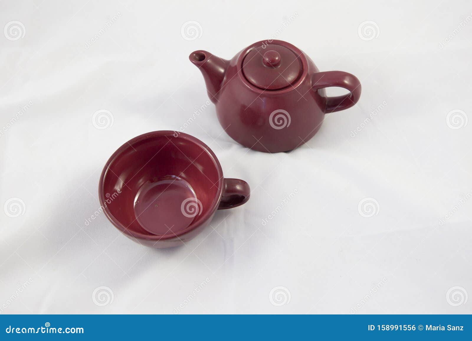 maroon ceramic teapot on white background