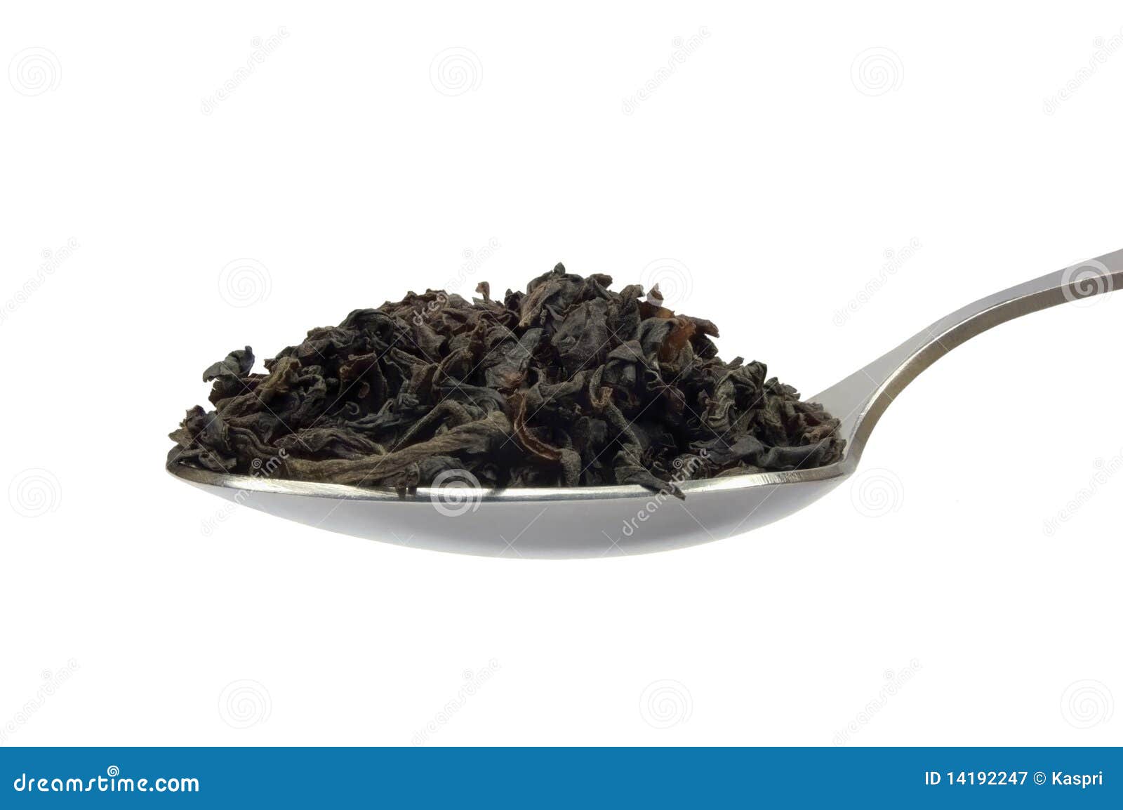 teaspoon with dark black tea leaf 