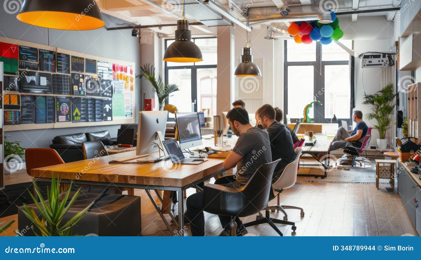 a tech startup team working collaboratively at a communal table