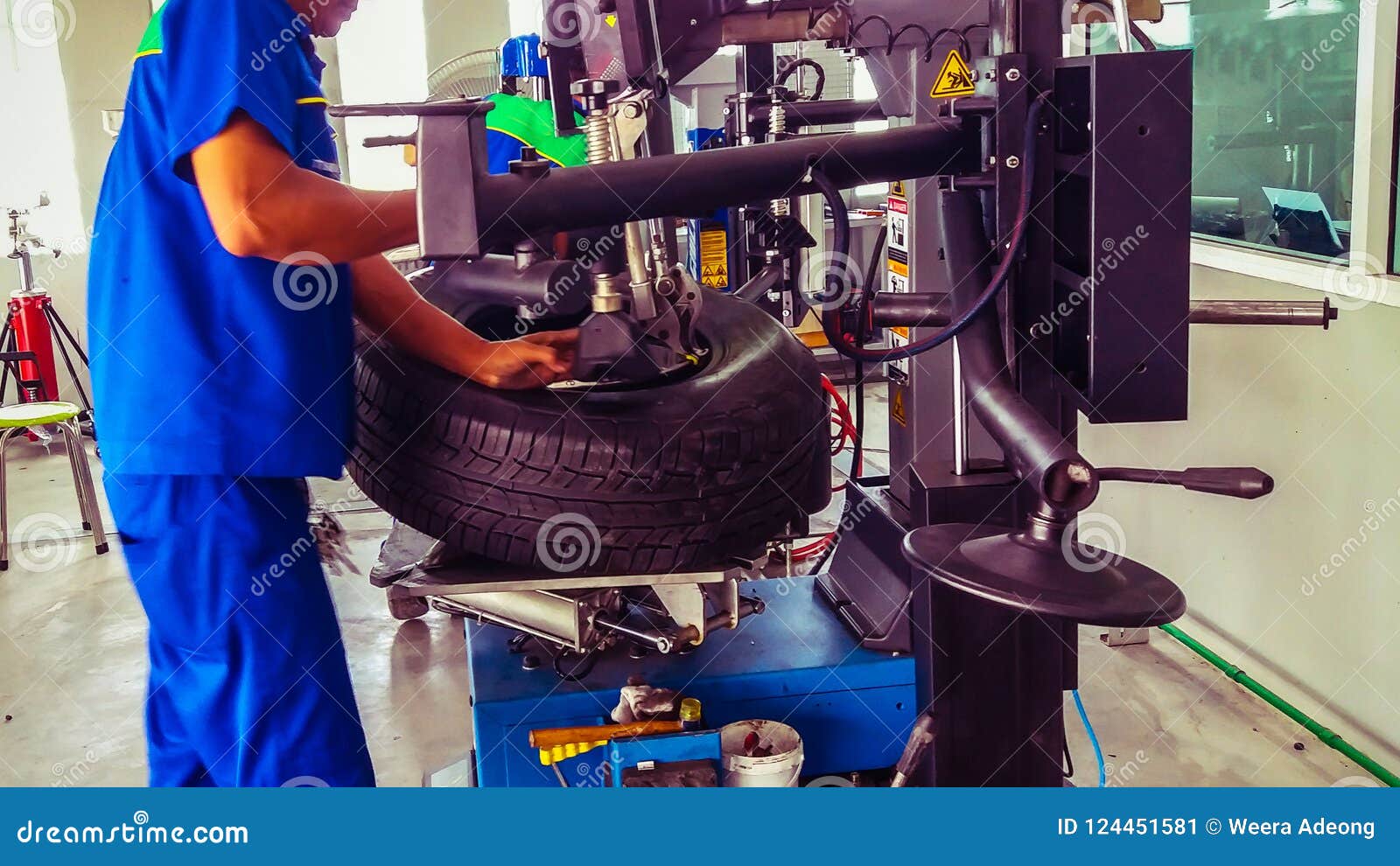 Technical during Tire Assembler in Tire Service Center Stock Image