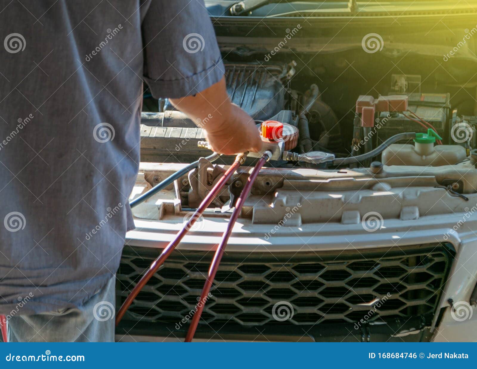 Technician Checking Air Conditioner in Engine Room of Eco Car