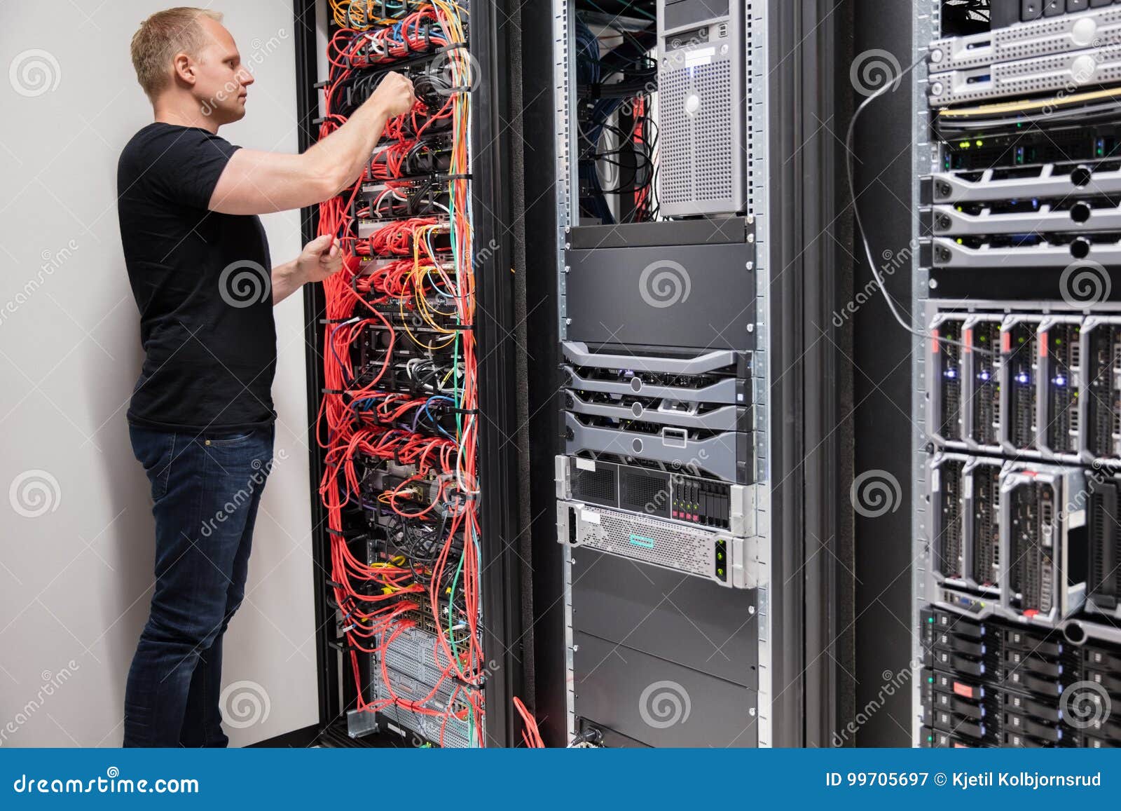 It Technician Checking with Network Cables Connected To Servers Stock