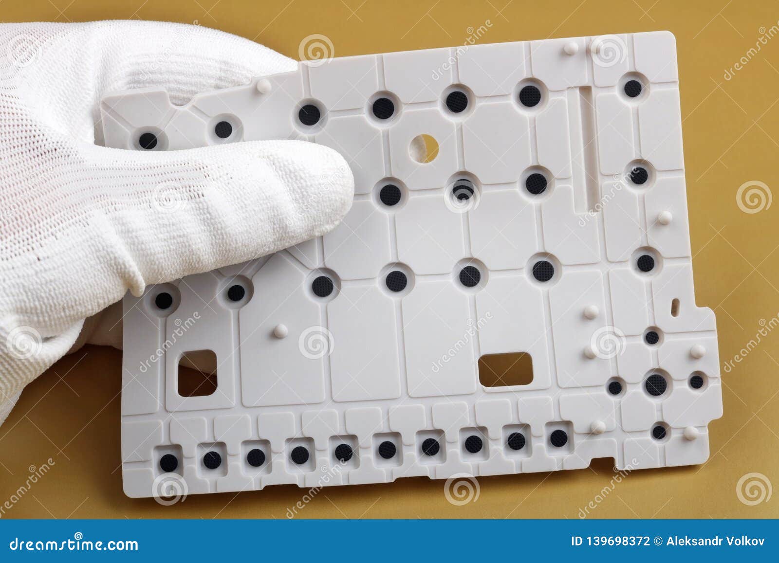a technician controls the quality of a rubber switch keyboard for mobile dvice