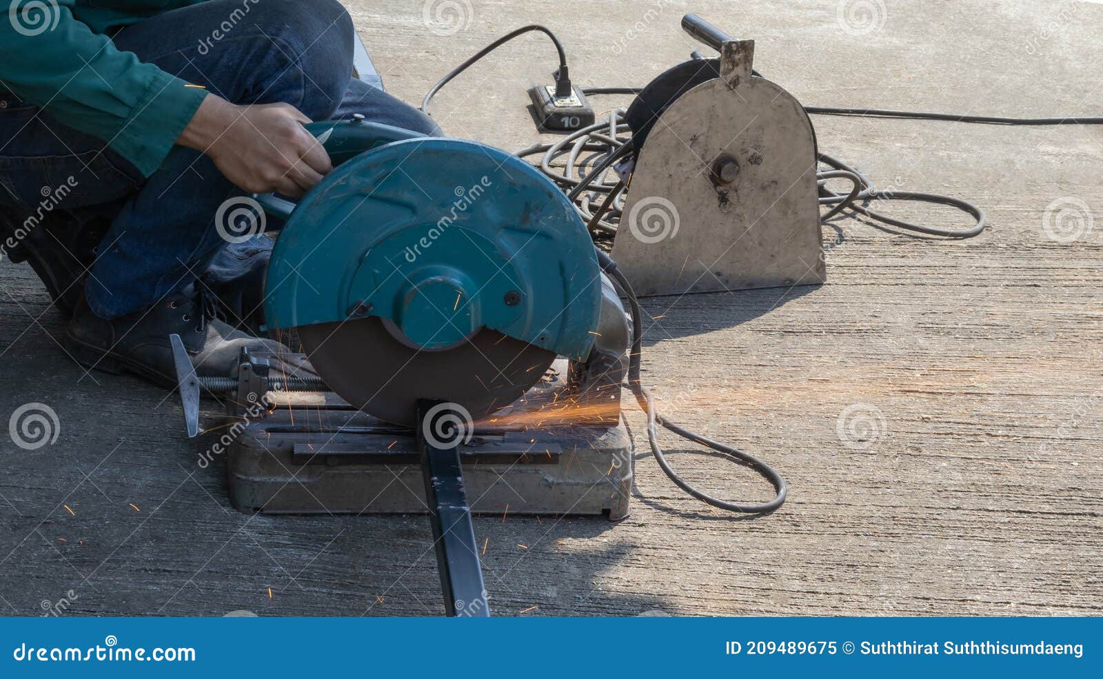 a technician is cutting steel using a cutting machine