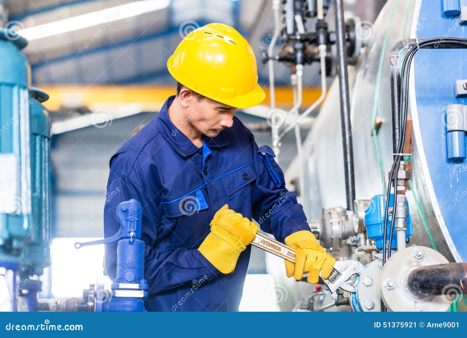 technician in factory at machine maintenance