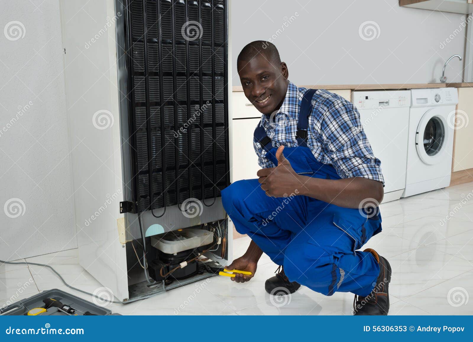 technician fixing refrigerator