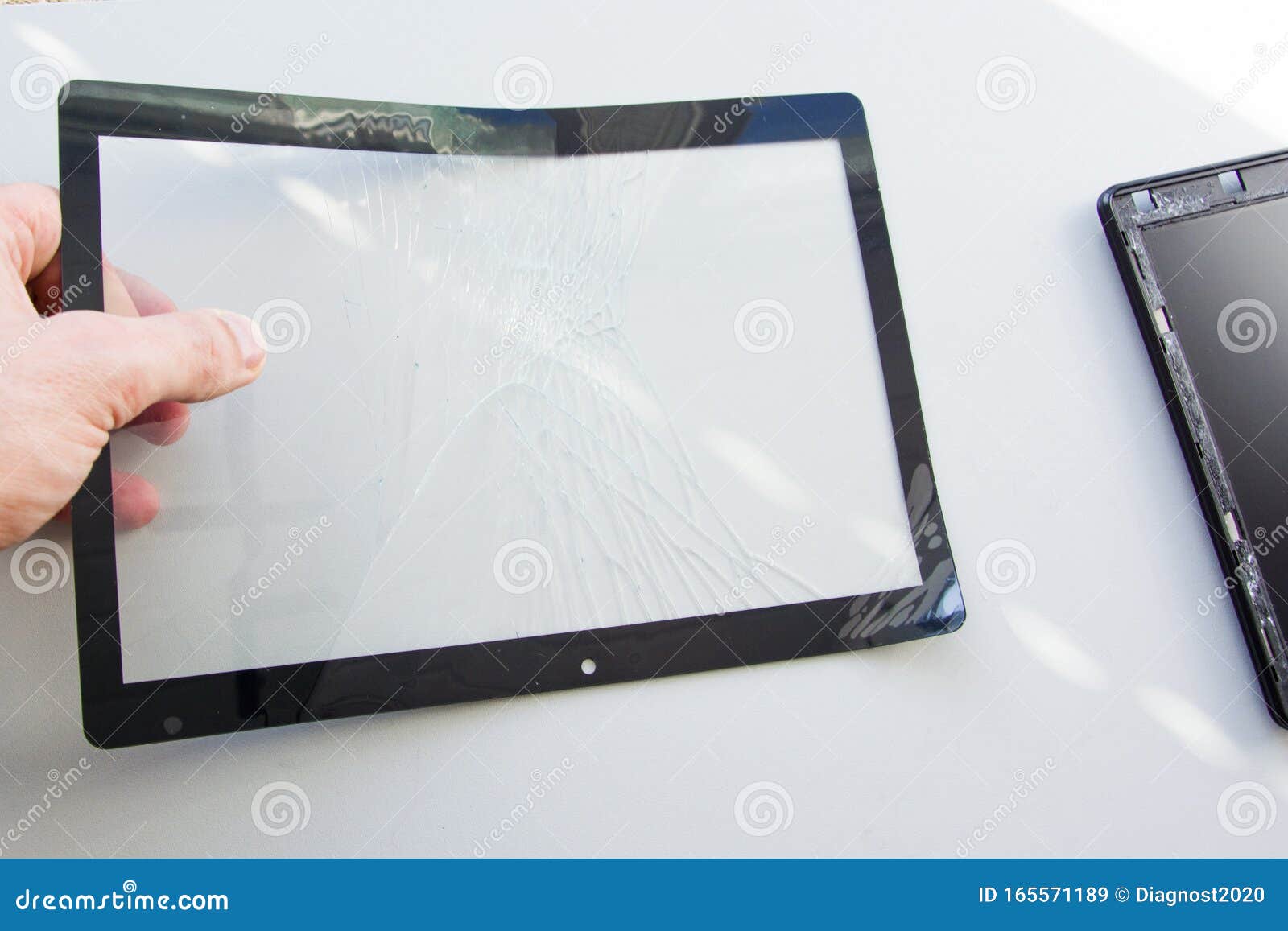 A Technician Holds in His Hand the Broken Touch Screen Glass of Tablet