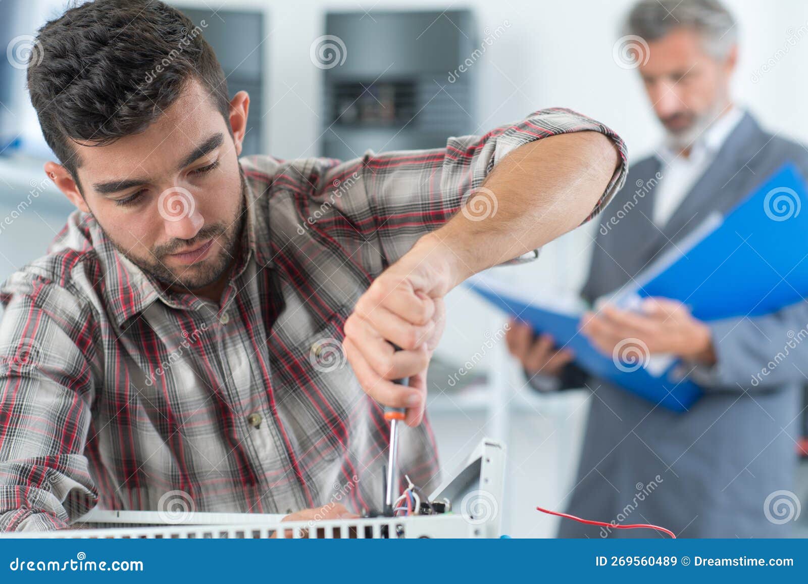 Technician Installing Digital Thermostat Using Screwdriver Stock Image