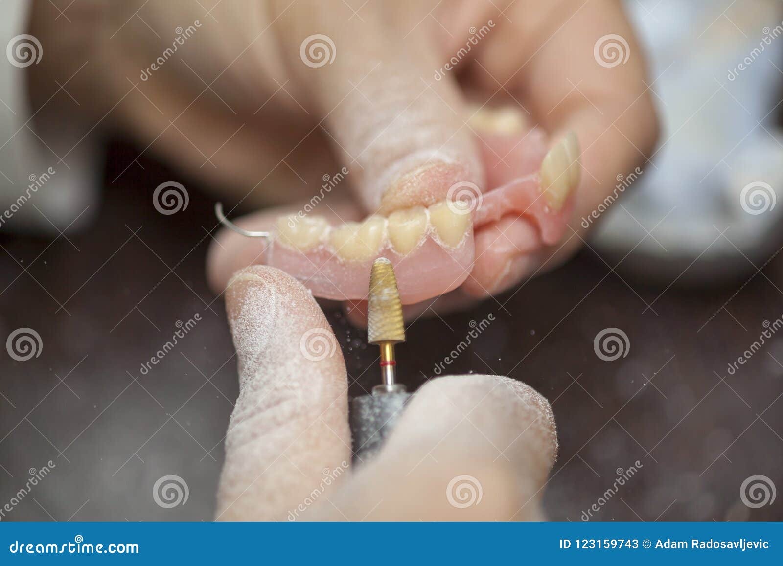 technician make denture prothesis in dental laboratory