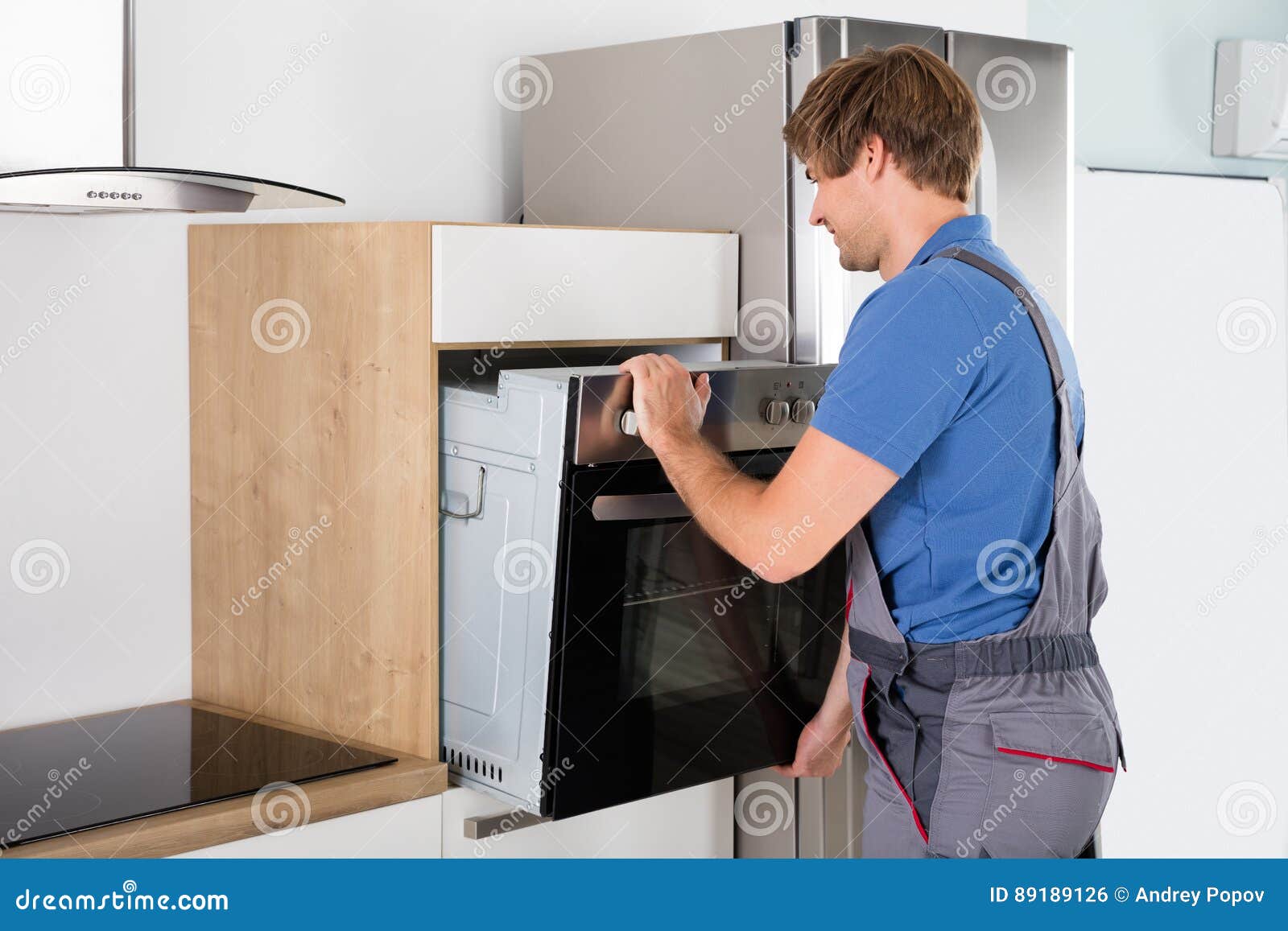Technician in Overall Installing Oven Stock Photo Image of caucasian