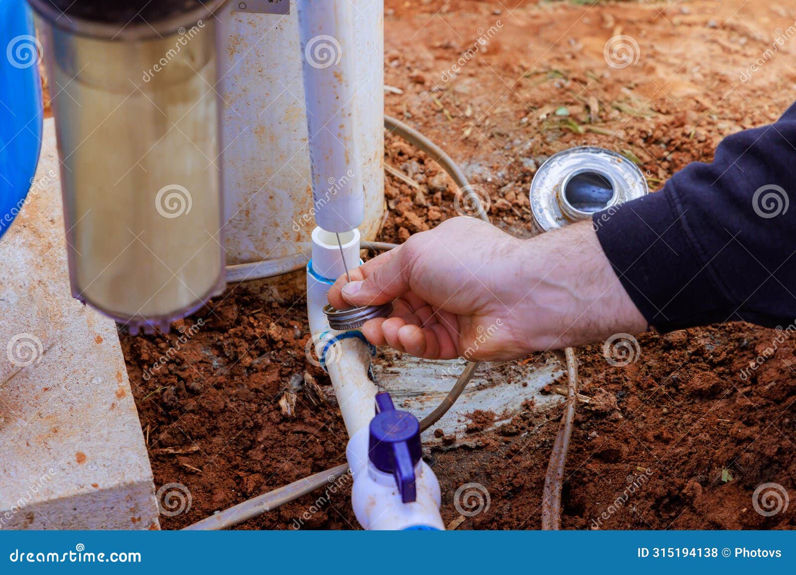 technician plumber uses clear primer for pvc pipe before a gluing it