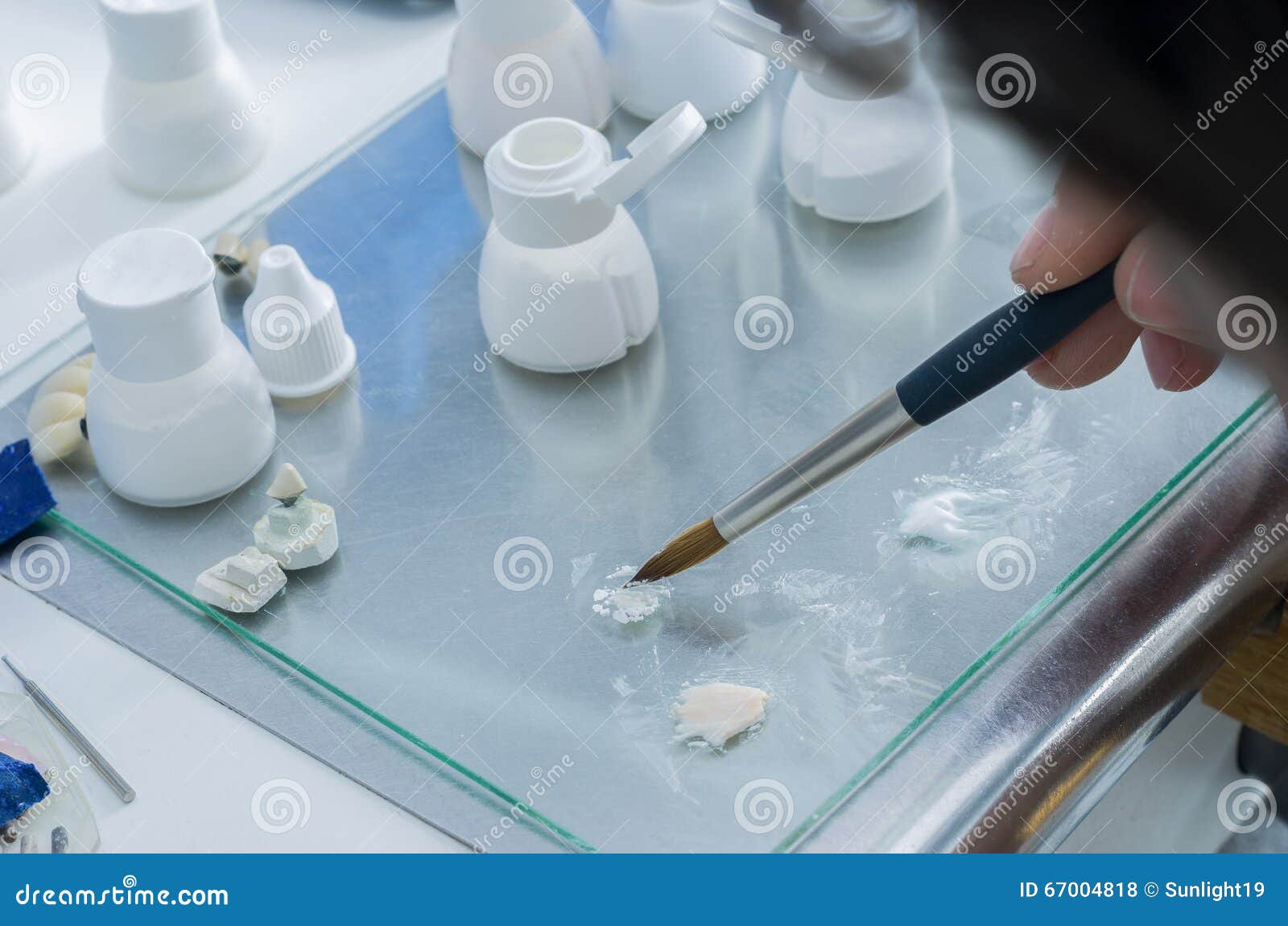 Technician Putting the Ceramic Material in Powder in the Glass. Stock