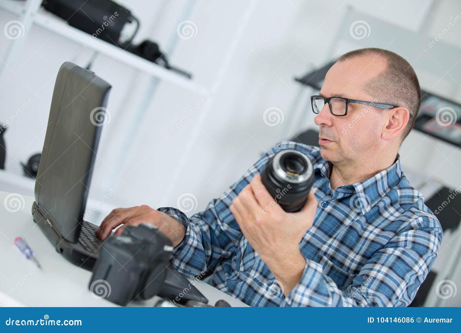 Technician Repairing Broken Digital Camera Lense in Stock