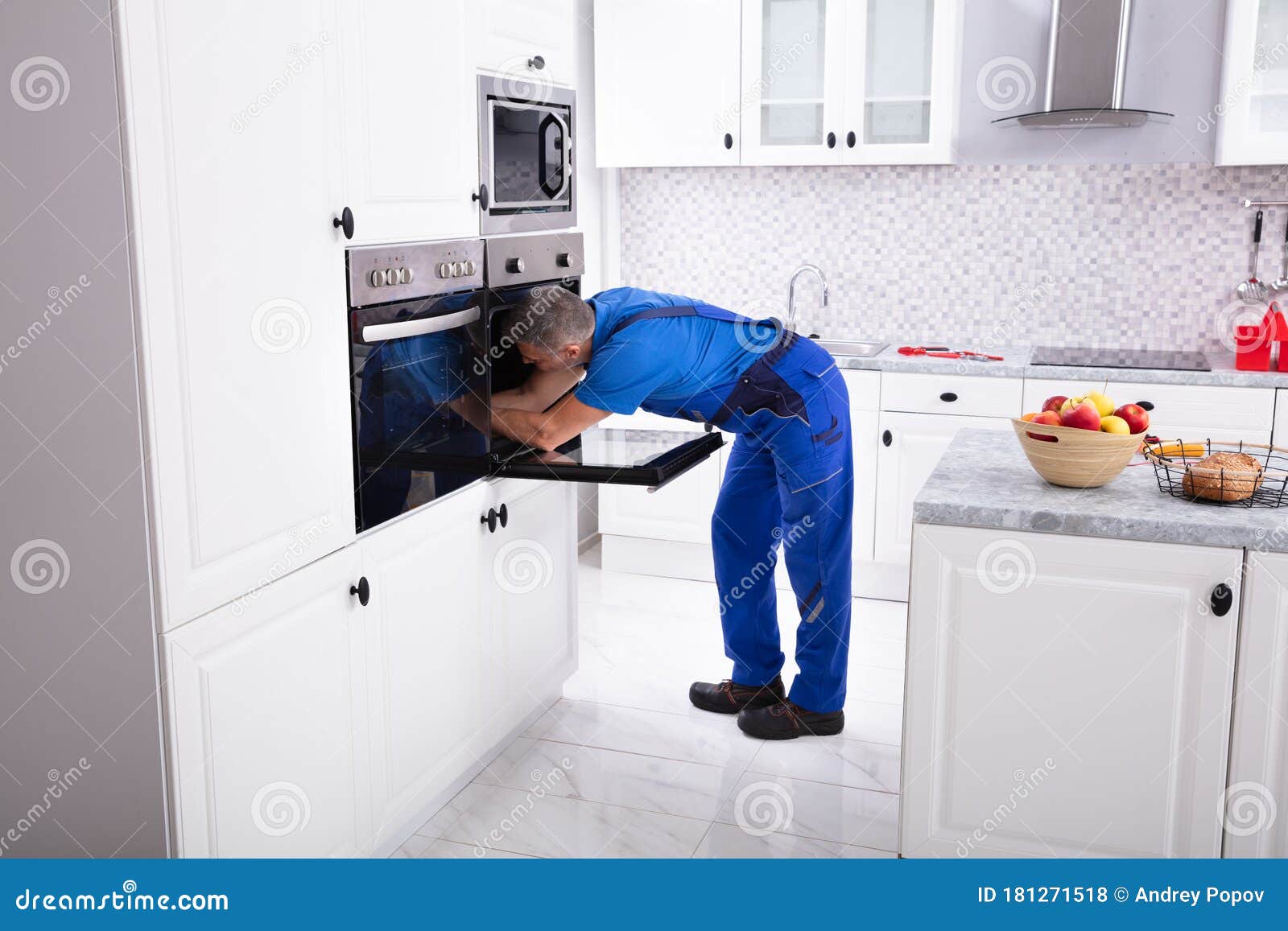 Technician Repairing Oven stock photo. Image of handyman 181271518