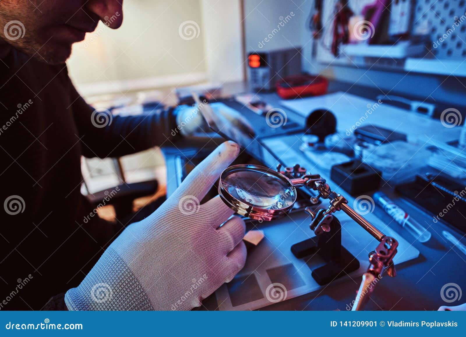 The Technician Repairs a Broken Tablet Computer in a Repair Shop Stock