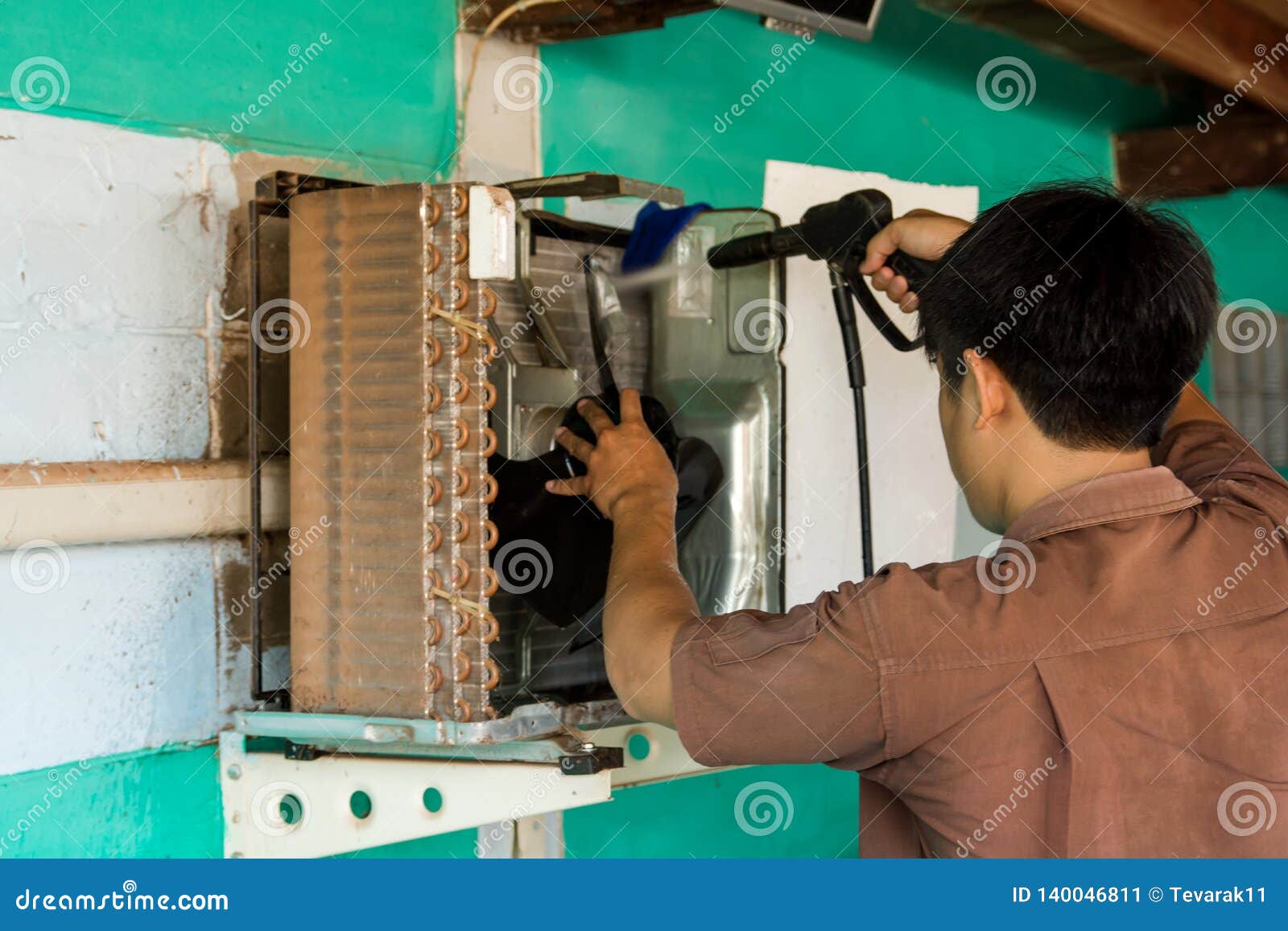 Technician are Servicing Repairing and Air Conditioners. Clean