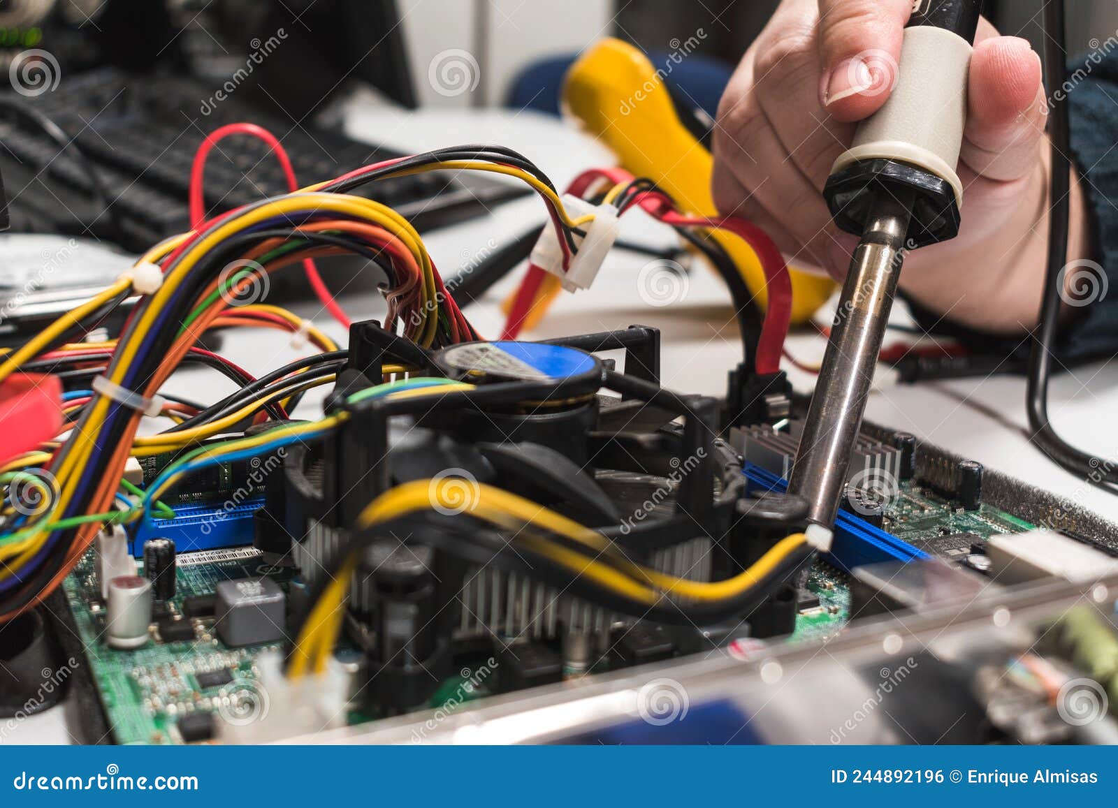 It Technician Soldering a Part of a Computer Motherboard in an Office