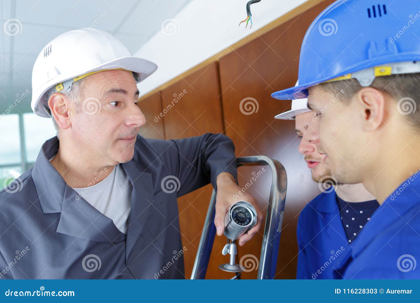 Technician Telling Students How To Installing Video Surveillance Camera