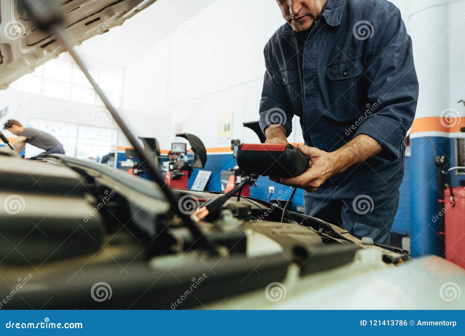 Technician Using Electronic Equipment To Diagnose the Car Stock Photo