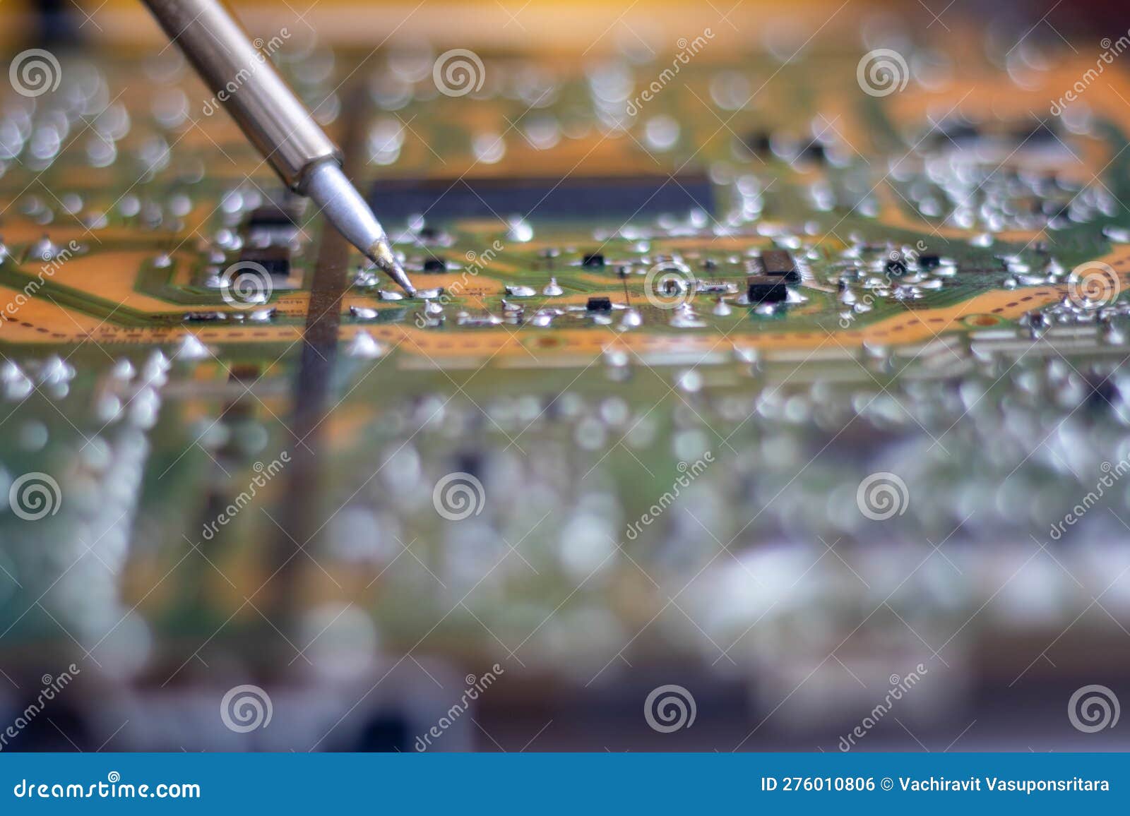 Technician Using a Soldering Iron To Repair a Circuit Board Stock Photo
