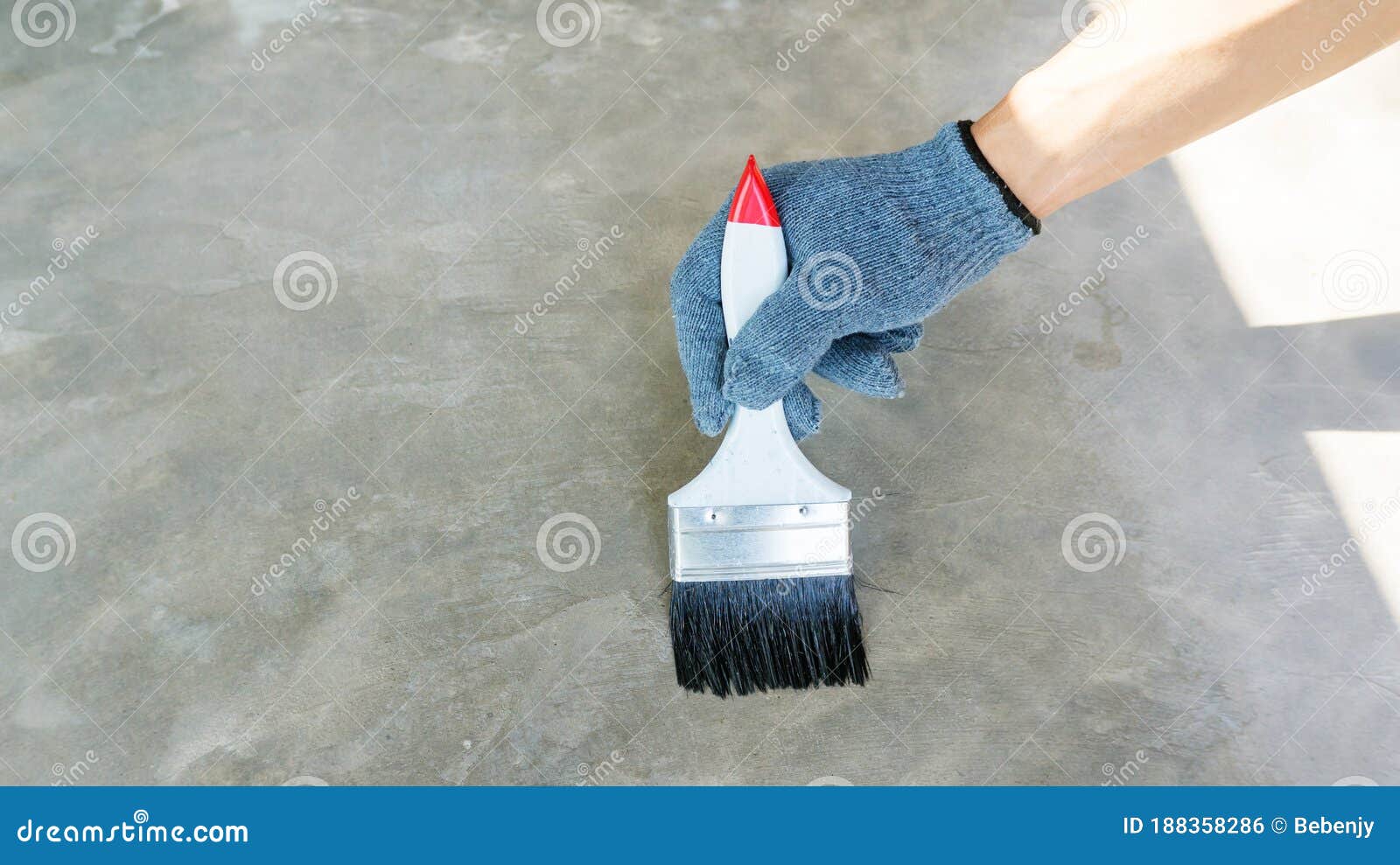 Technician Using a Varnish Paint with a Cement Floor Stock Photo