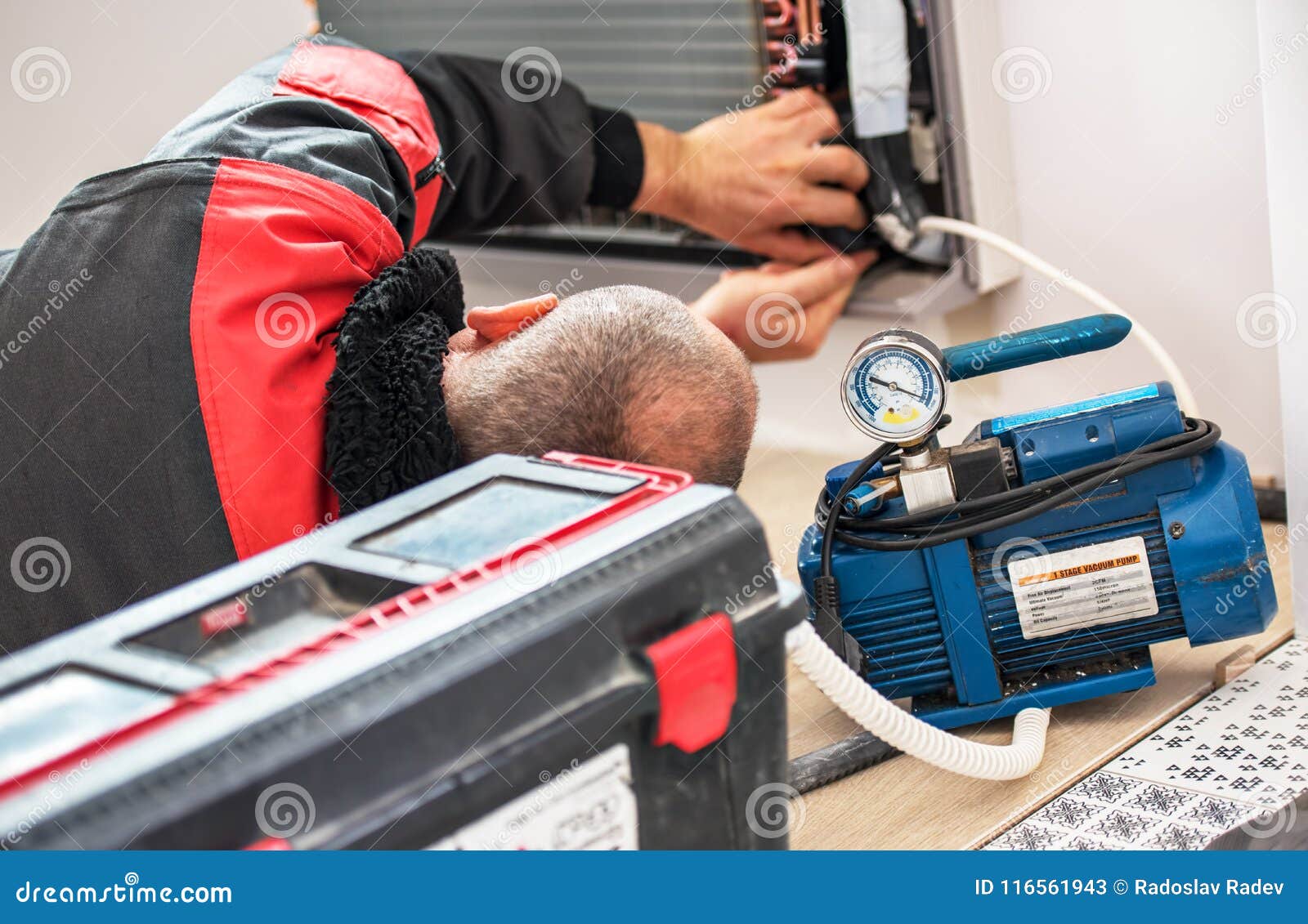 Technician Vacuum Pump Evacuates and Checking New Air Conditioner
