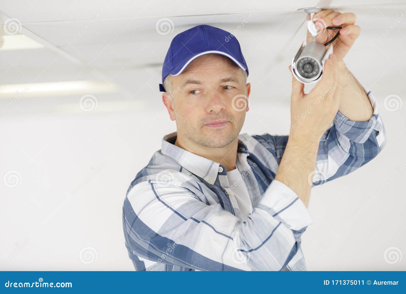 Technician Worker Installing Video Surveillance Camera on Wall Stock
