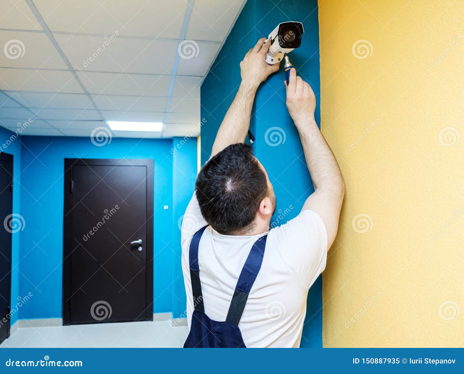Technician Worker Installing Video Surveillance Camera Stock Image