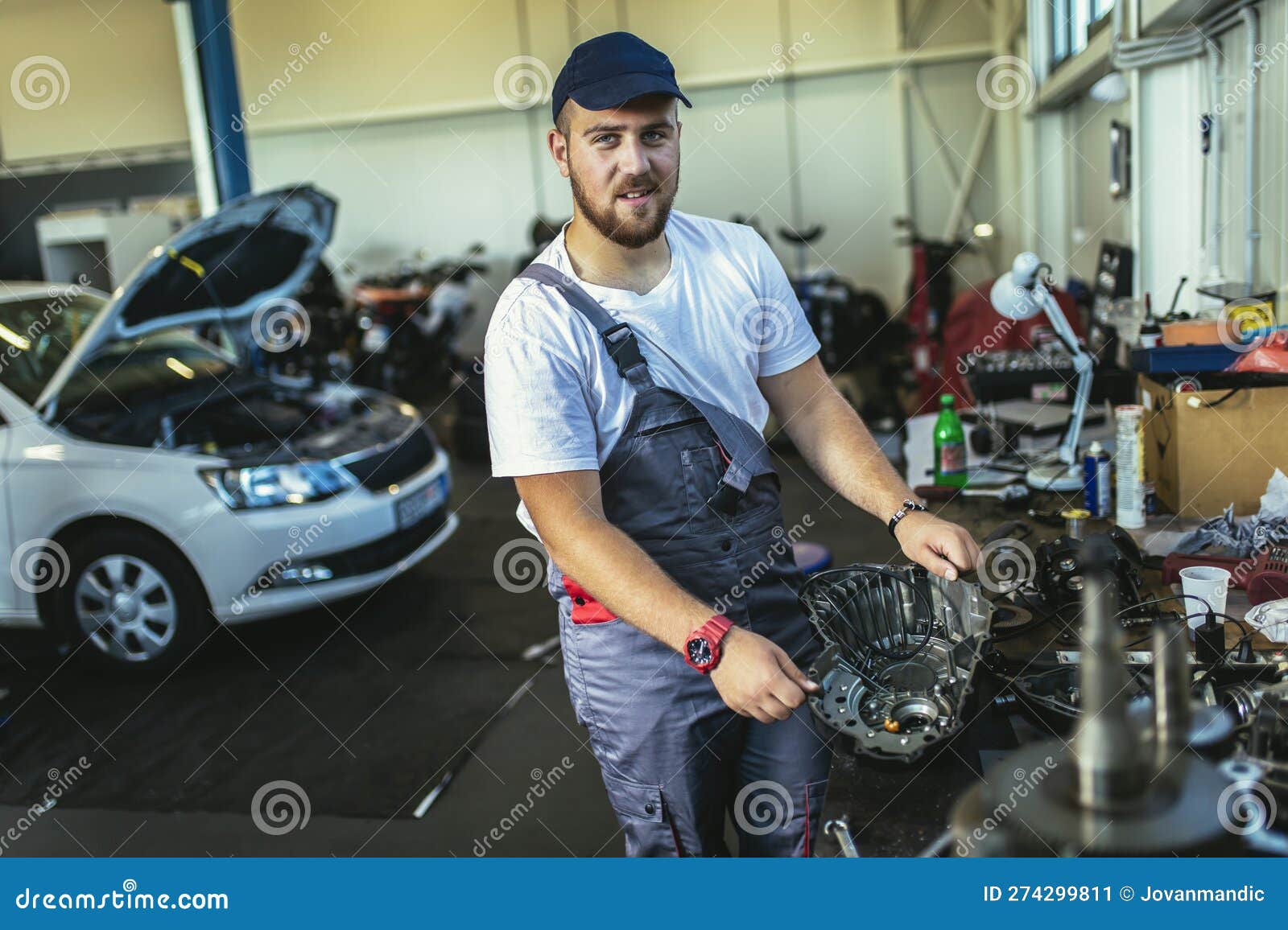 Technician Working on Checking and Service Car in Garage