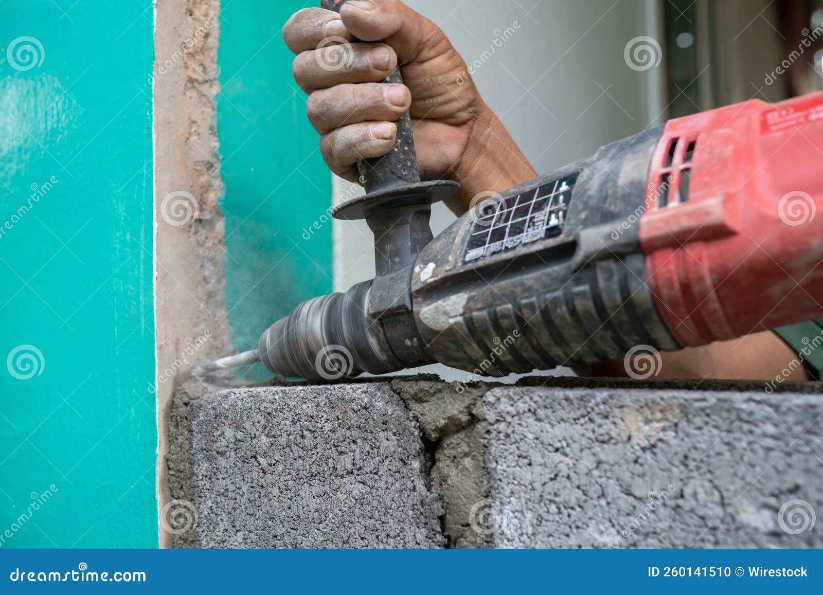 Technicians Use a Drill To Drill Holes in the Masonry To Strengt Stock