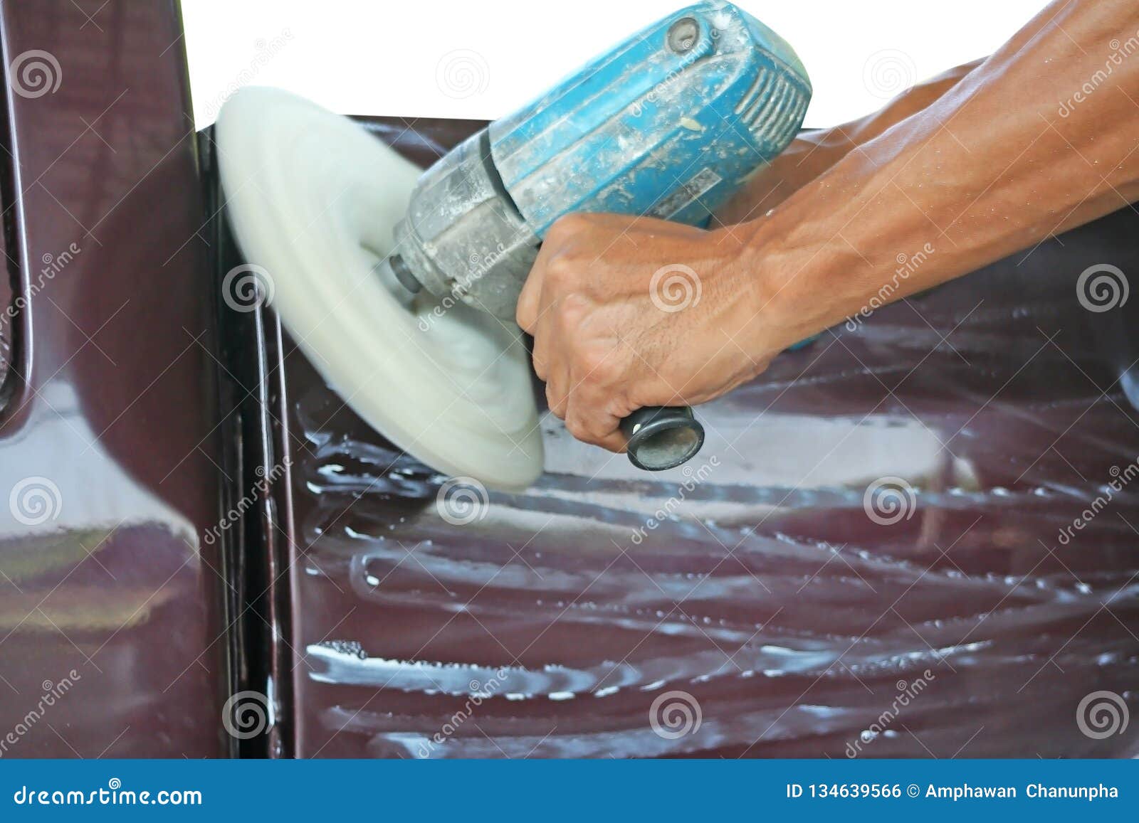 Automotive Paint Technician Using Grinder Machine with Wax on Side of