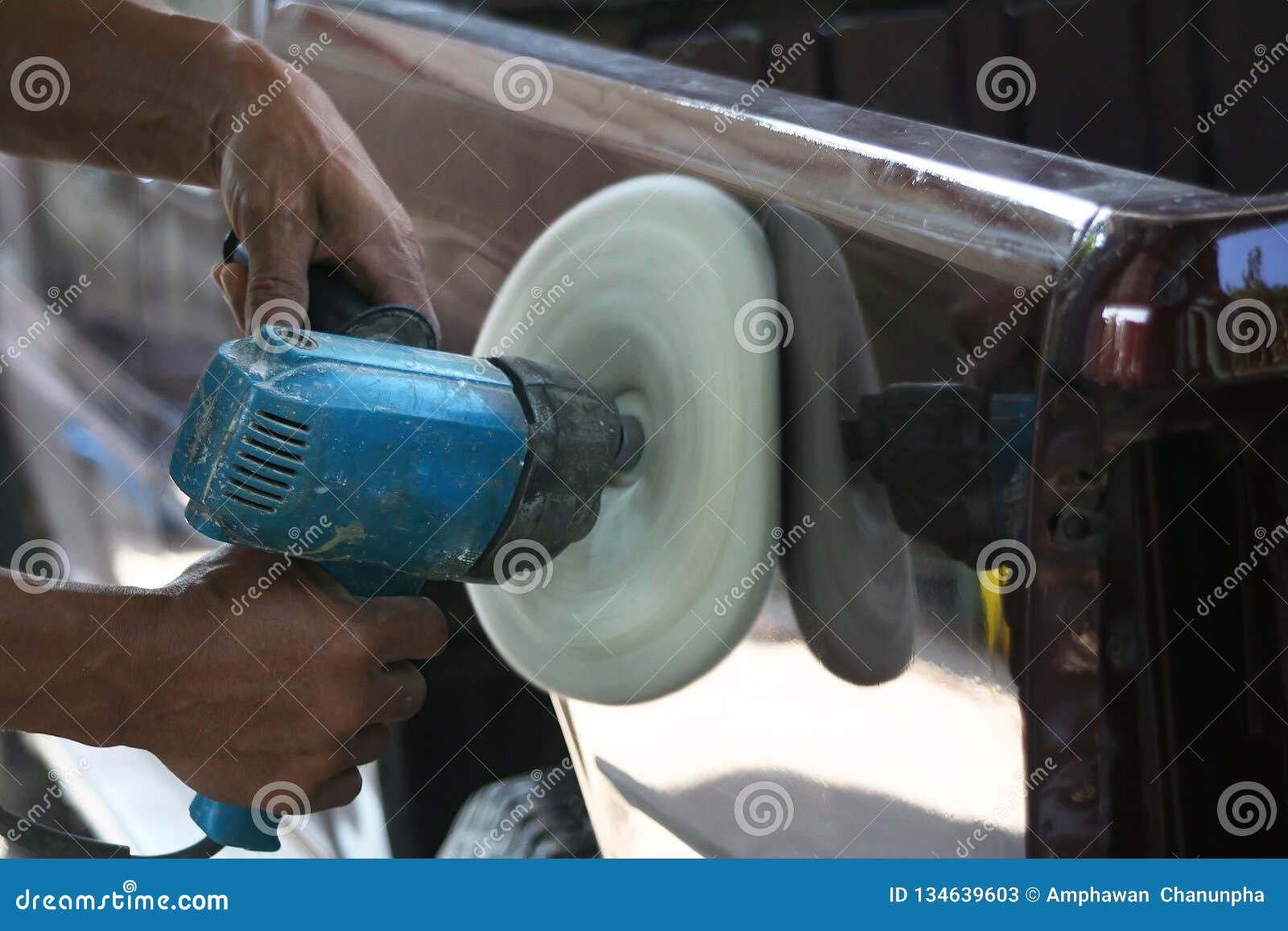Automotive Paint Technician Using Grinder Machine with Wax on Side of