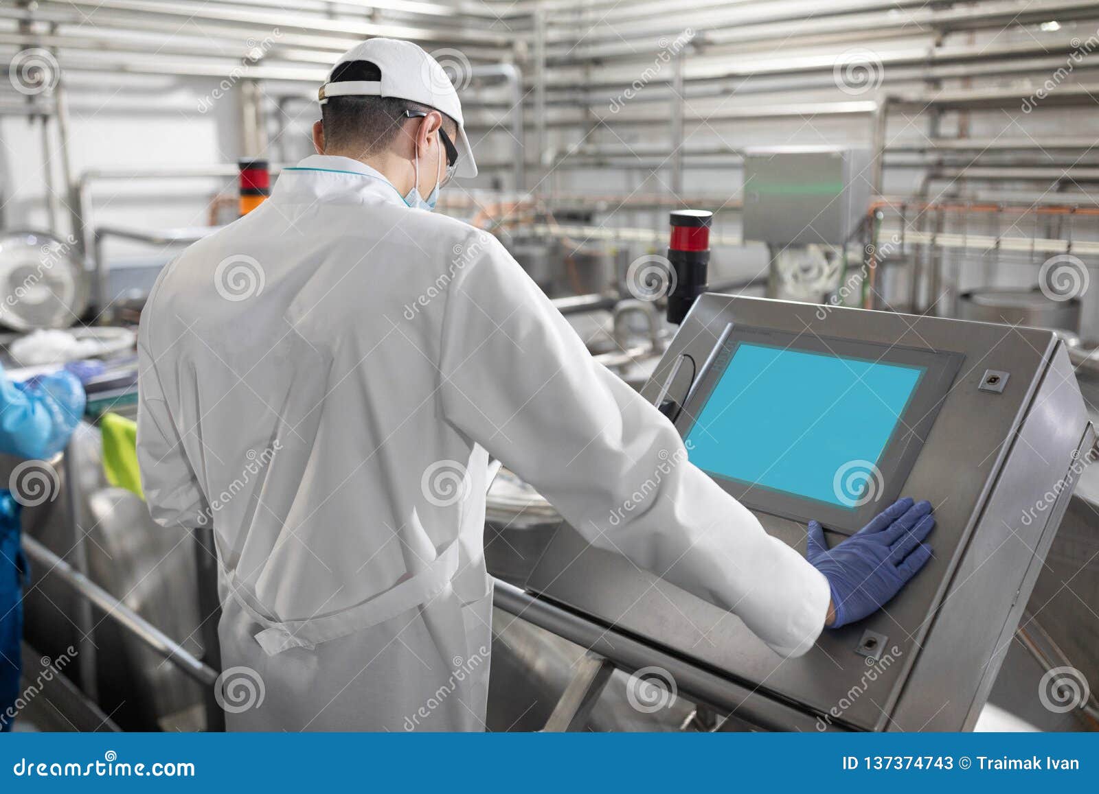 Technologist Taking Necessary Notes while Standing at Production